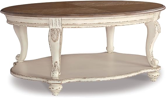 Signature Design by Ashley Realyn Oval Coffee Table, White/Brown | Antiqued two-tone wood, Fixed lower shelf, 48 in width, Farmhouse style, Living room centerpiece